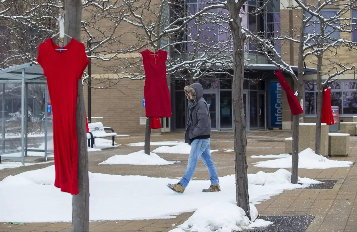 red dresses hang in trees on the Brock University campus