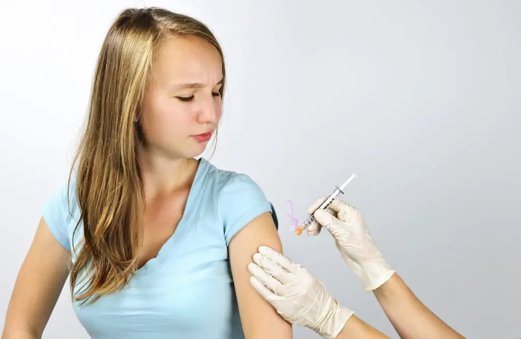 teen gets vaccine shot